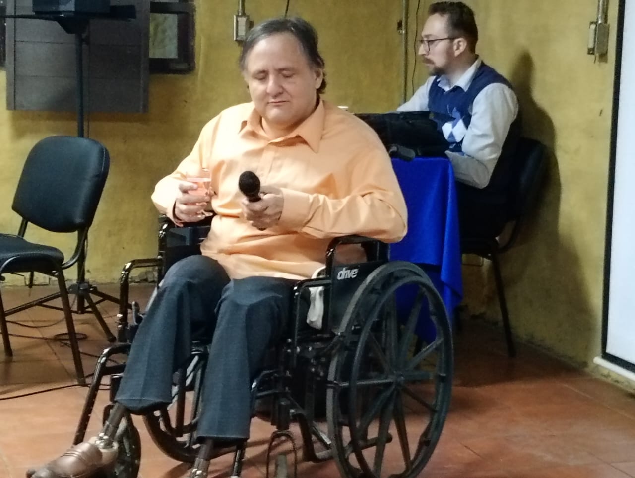 Em primeiro plano, sentado numa cadeira de rodas, Claudio Regidor. Atrás, à mesa escrevendo, Andrés Cabrera