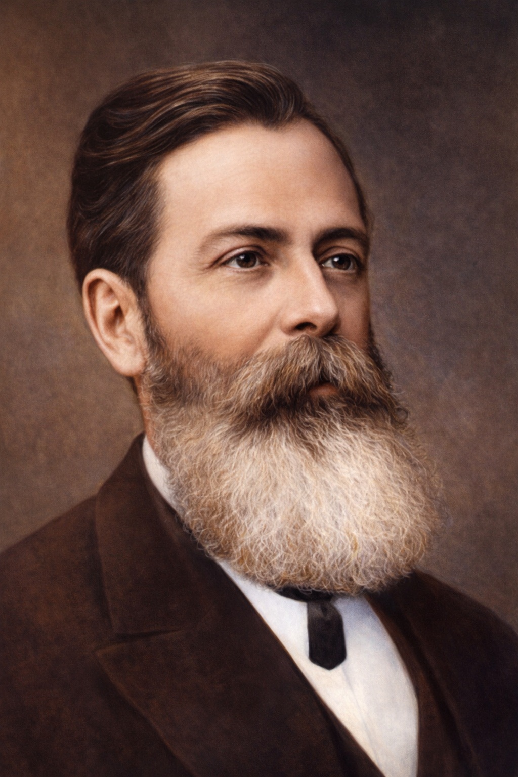 Retrato colorizado de José de Alencar, escritor cearense e Patrono do Romantismo Brasileiro, apresentado em composição clássica do século XIX. A imagem evidencia sua expressão serena e intelectual, com vestimenta formal da época, barba longa e olhar contemplativo, simbolizando a sobriedade, o humanismo e o legado literário que marcou a formação da identidade cultural brasileira. Imagem criada por IA do chat GPT.